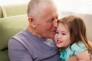 Grandpa kissing hia granddaughter